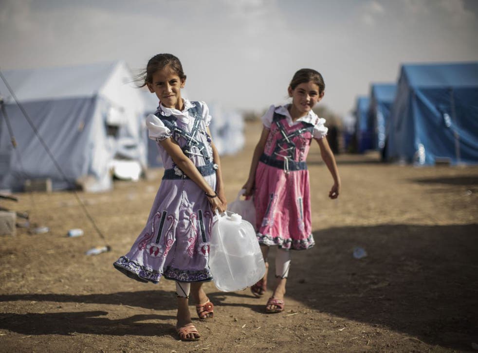 Two Iraqi girls in a temporary camp near the Kurdish region on Friday 