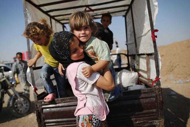 Families arrive at a Kurdish camp (Getty)