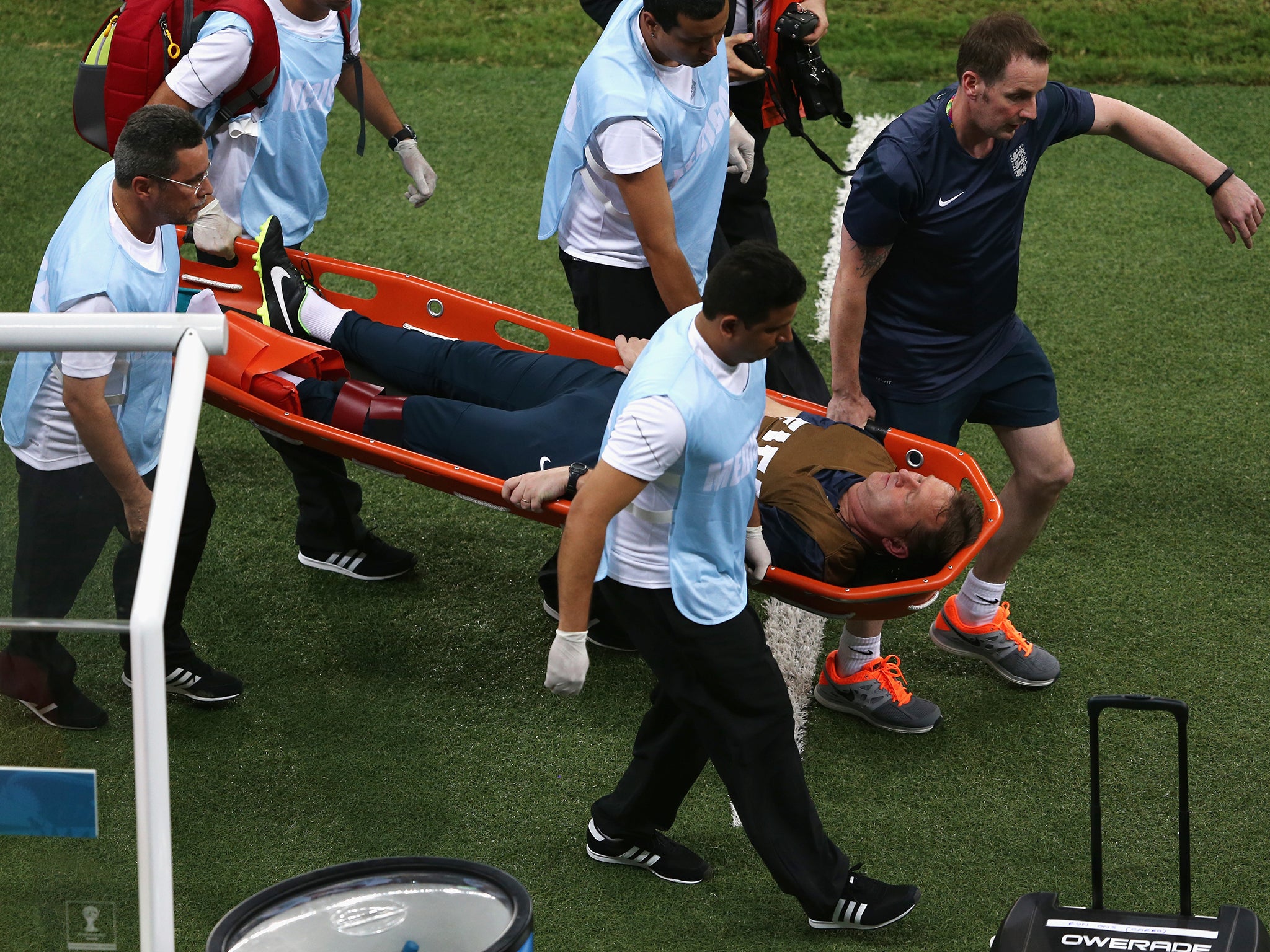 Gary Lewin is stretchered off, dislocating his ankle after landing on a water bottle