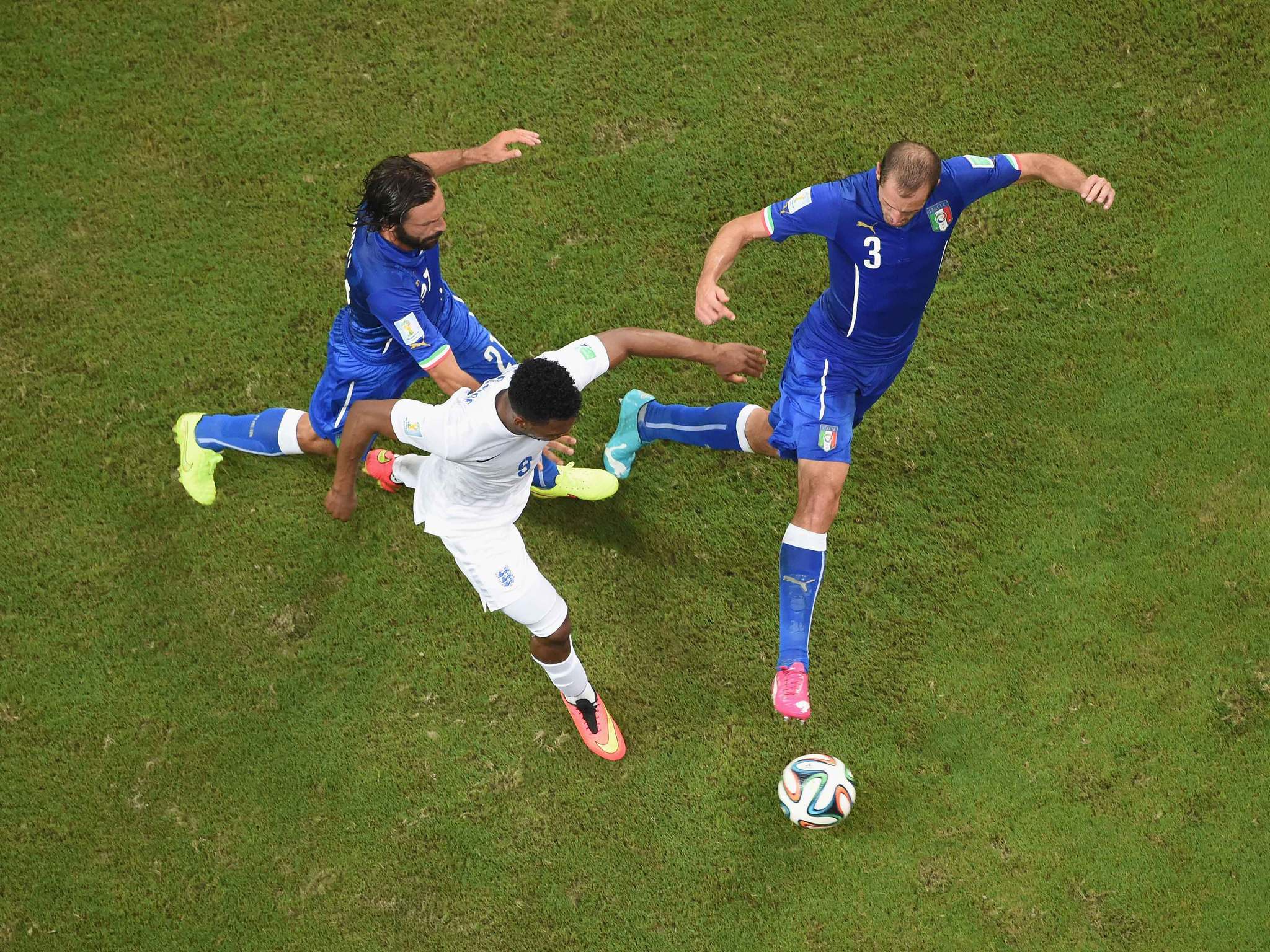 Andrea Pirlo and Giorgio Chiellini of Italy close down Daniel Sturridge of England during the World Cup Brazil Group D match between England and Italy in Manaus, Brazil.