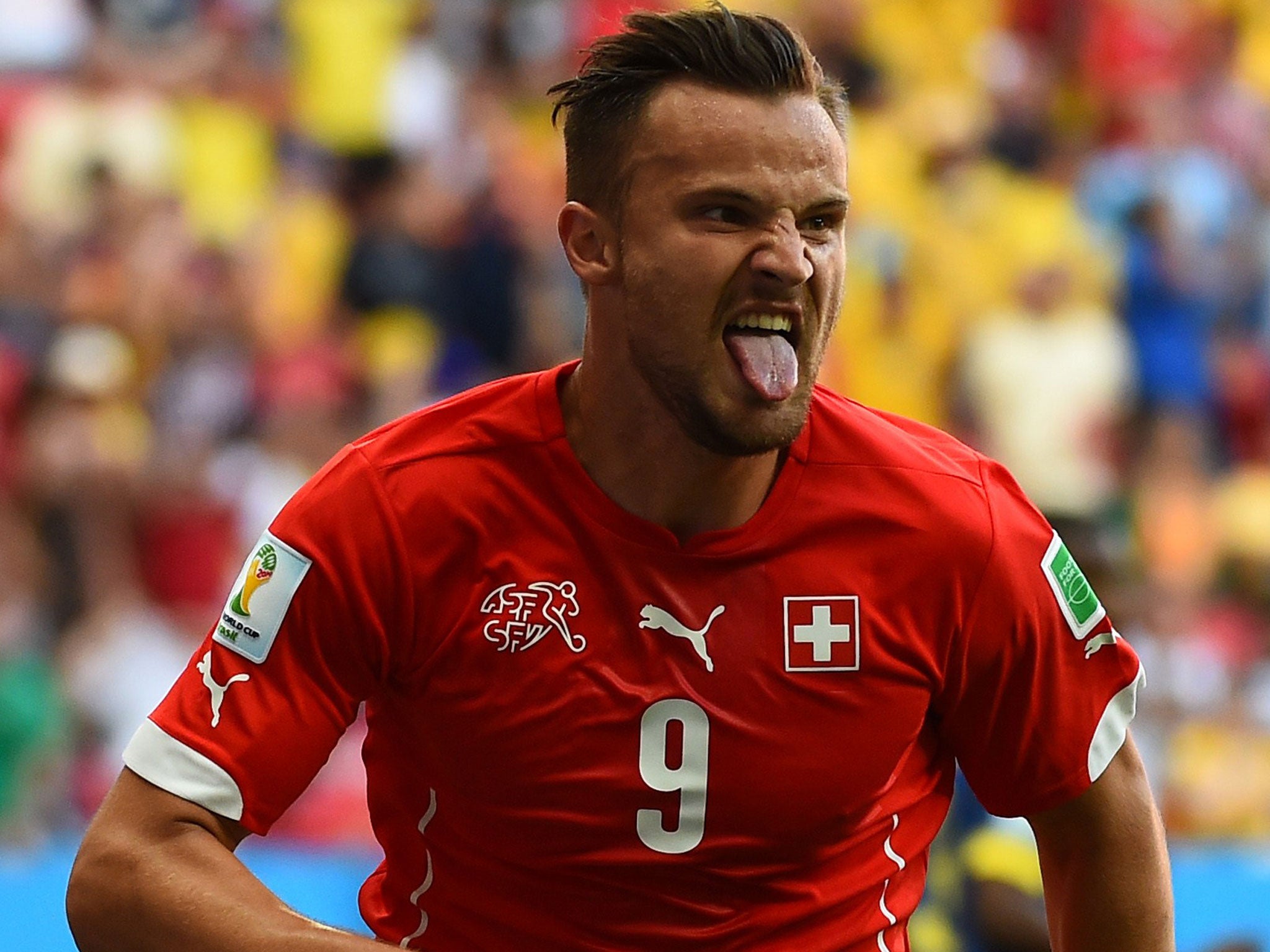 Switzerland substitute Haris Seferovic wheels away in celebration