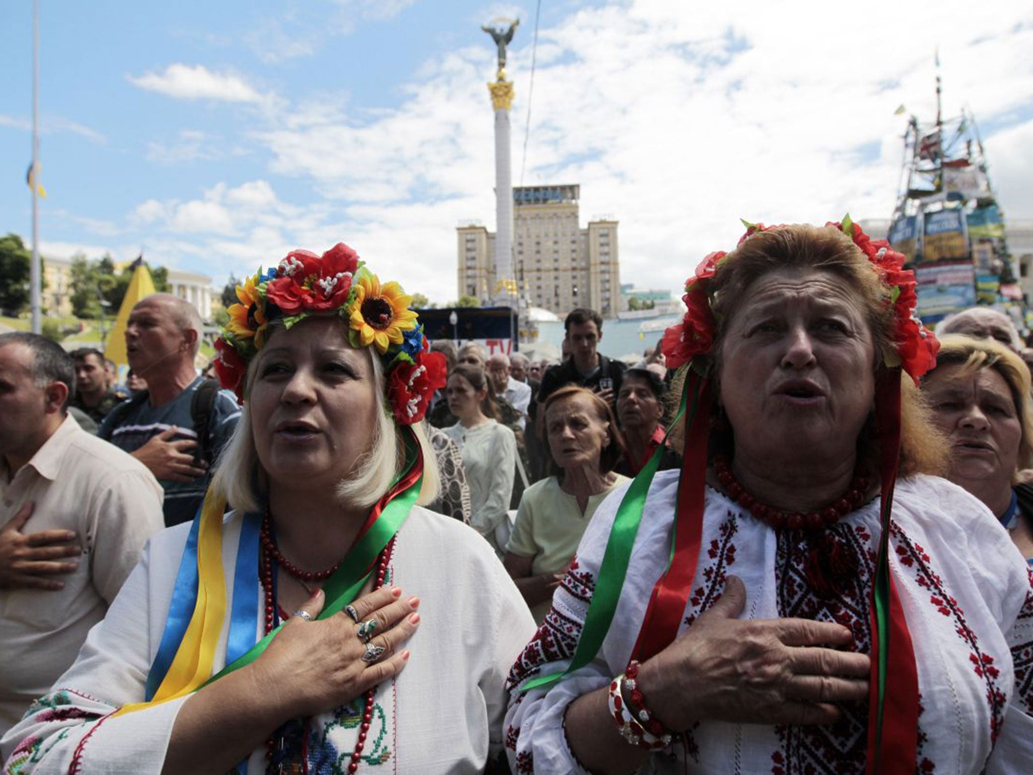 People gather in Kiev yesterday as Ukraine’s President declared Sunday a day of mourning for the downed plane victims (AP)