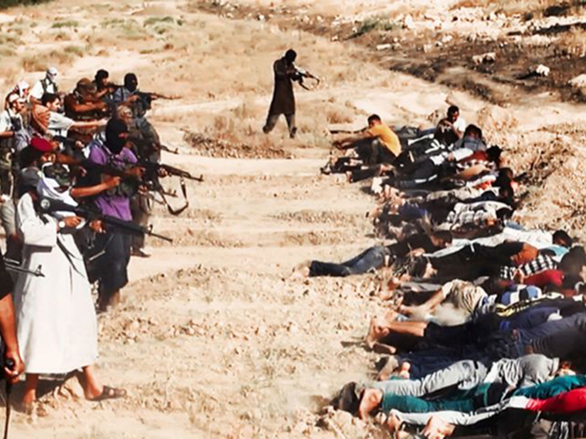 A picture posted on a militant website reportedly shows jihadists from Isis taking aim at captured Iraqi soldiers wearing plain clothes, after taking over a base in Tikrit