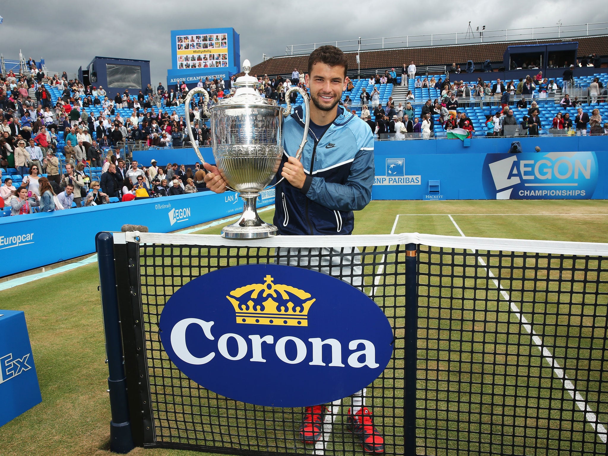 Grigor Dimitrov poses with his Queen's trophy