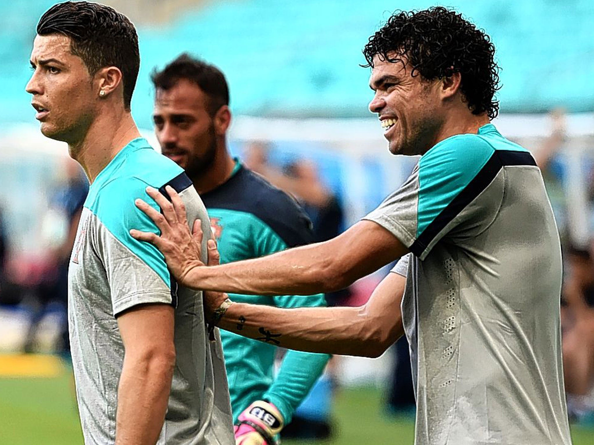 Cristiano Ronaldo is given a friendly shove by Pepe during training in Salvador