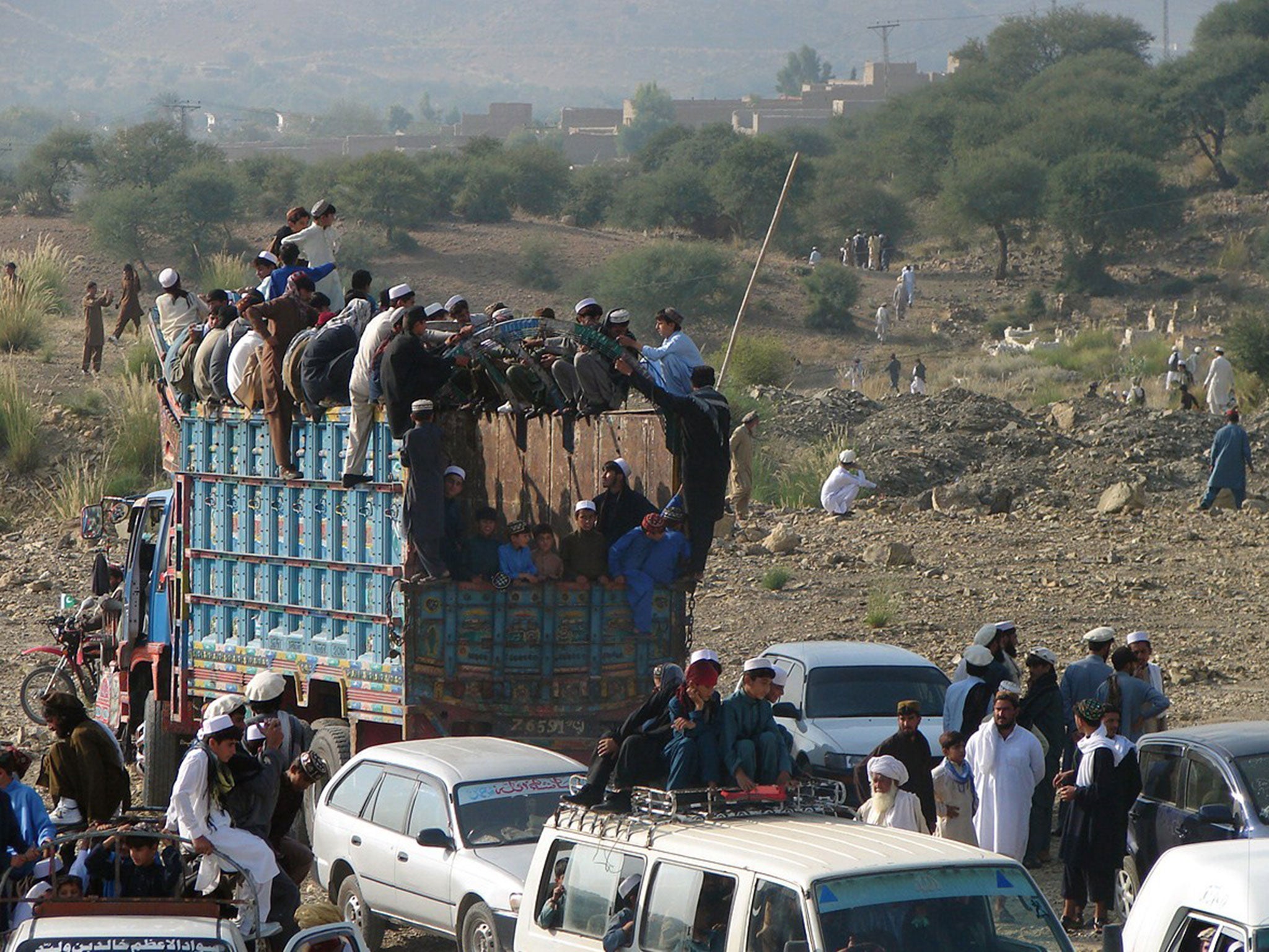 Fleeing internally displaced Pakistanis, stuck in a curfew imposed due to the Afghan election, are pictured near the mountainous North Waziristan district Miranshah on 14 June 2014