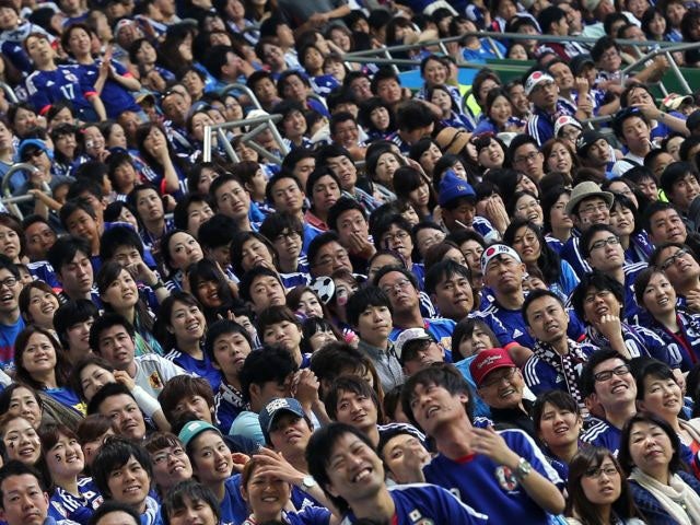 Japanese fans watch the live broadcast of the 2014 FIFA World Cup match between Japan and Ivory Coast