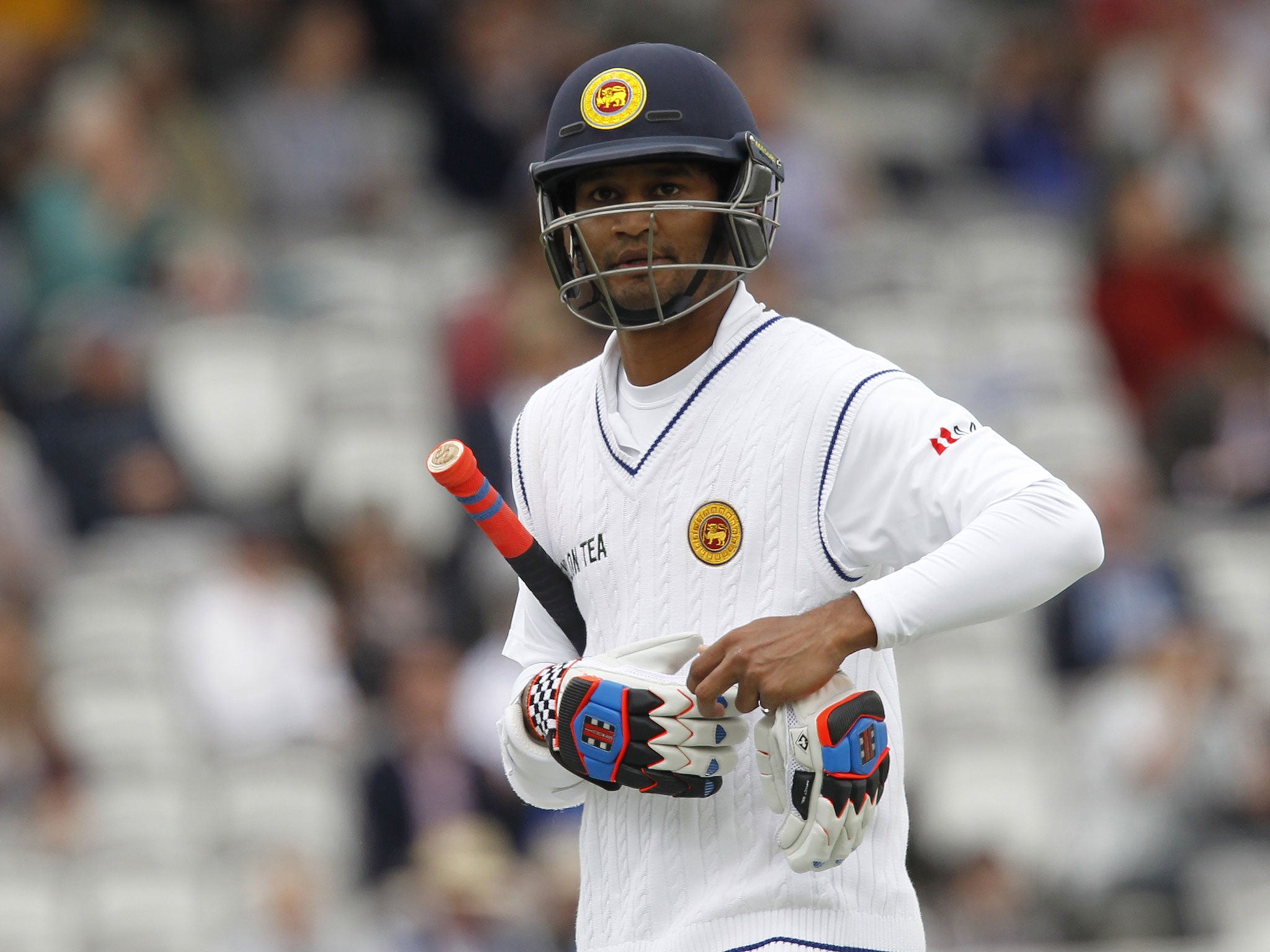 Sri Lankas Dimuth Karunaratne walks back to the pavilion after getting out for 16 runs during play on the fifth day of the first cricket Test match between England and Sri Lanka at Lord's