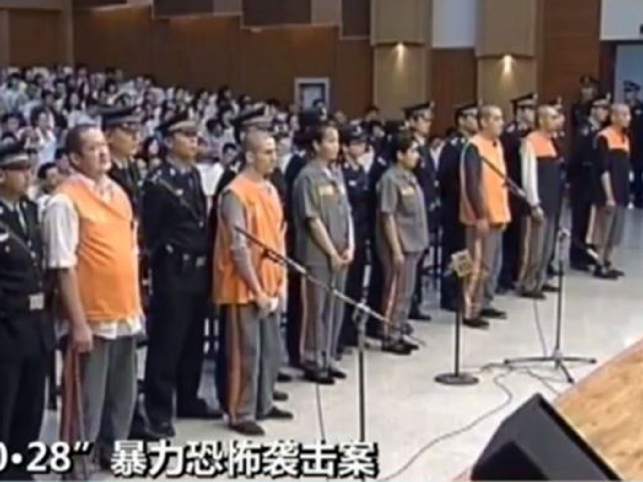 This screen grab taken from China Central Television shows  the prisoners upon their arrival at the Intermediate People's Court in the Xinjiang capital, Urumqi