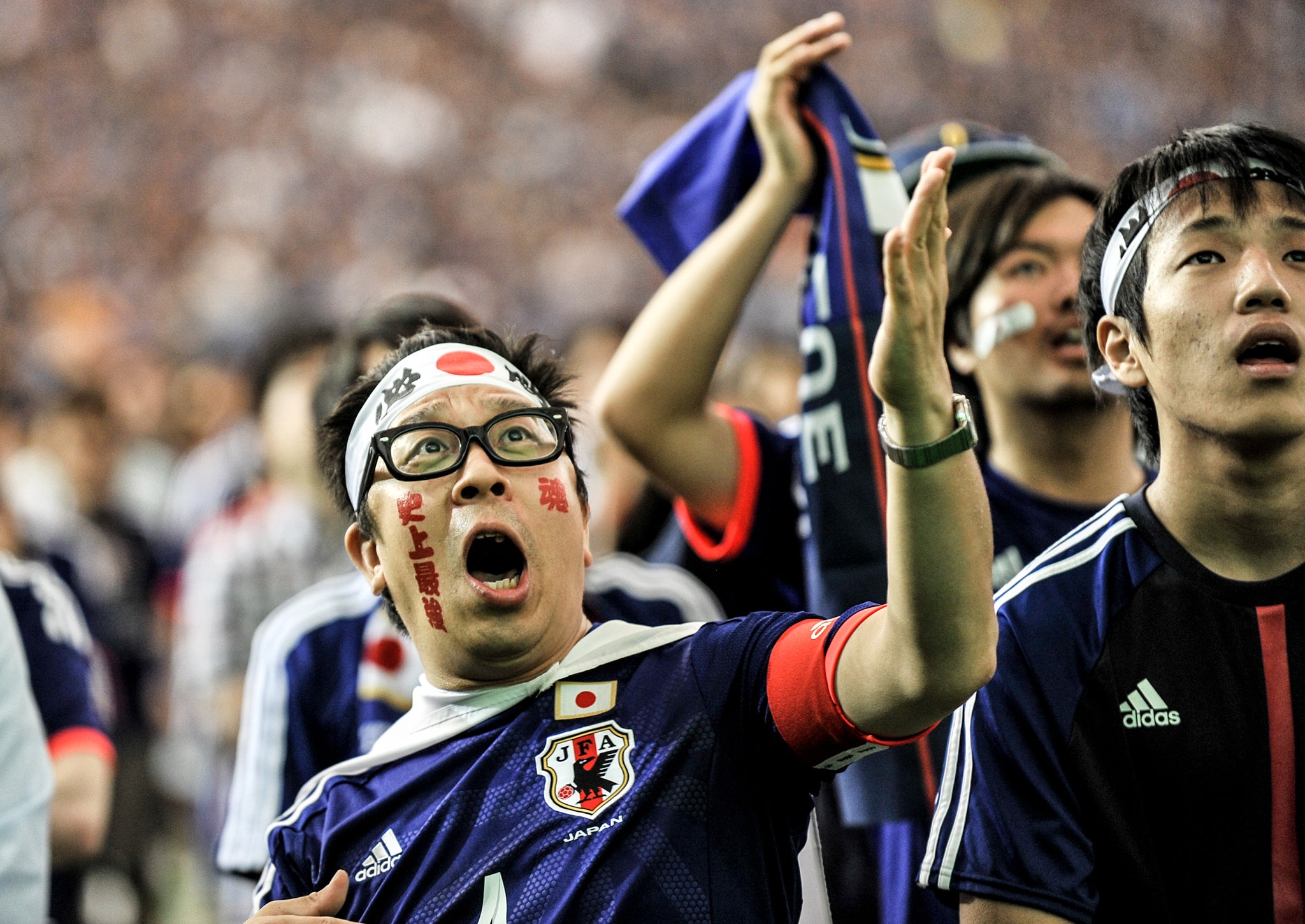 Japanese fans cheer on their team during the 2014 FIFA World Cup match between Japan and Cote d'Ivoire during the public viewing event at Tokyo Dome on June 15
