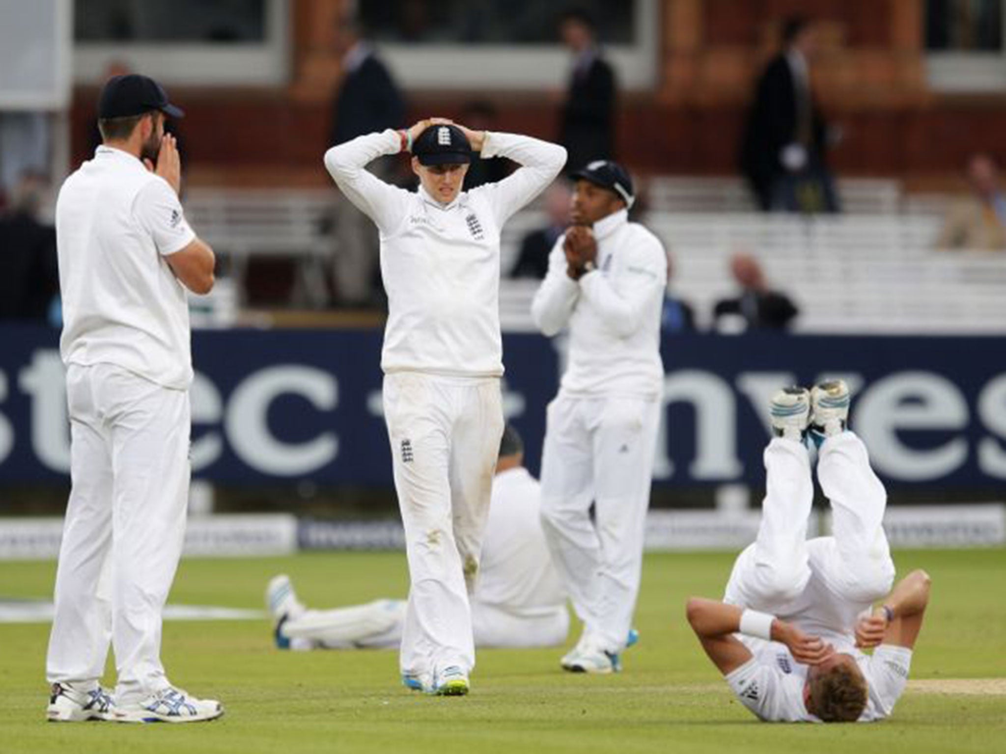 Chris Jordan, second right, clutches the ball that fell just short of him at slip off the final delivery of the first Test yesterday as his England team-mates look dejected