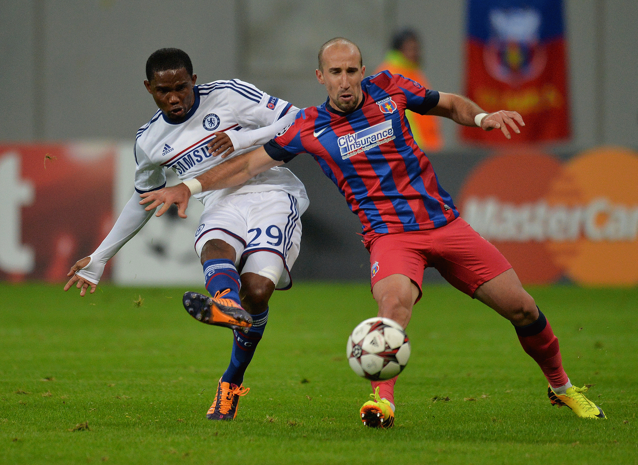 Steaua Bucharest defender Iasmin Latovlevici (right) battles with Chelsea's Samuel Eto'o (left)