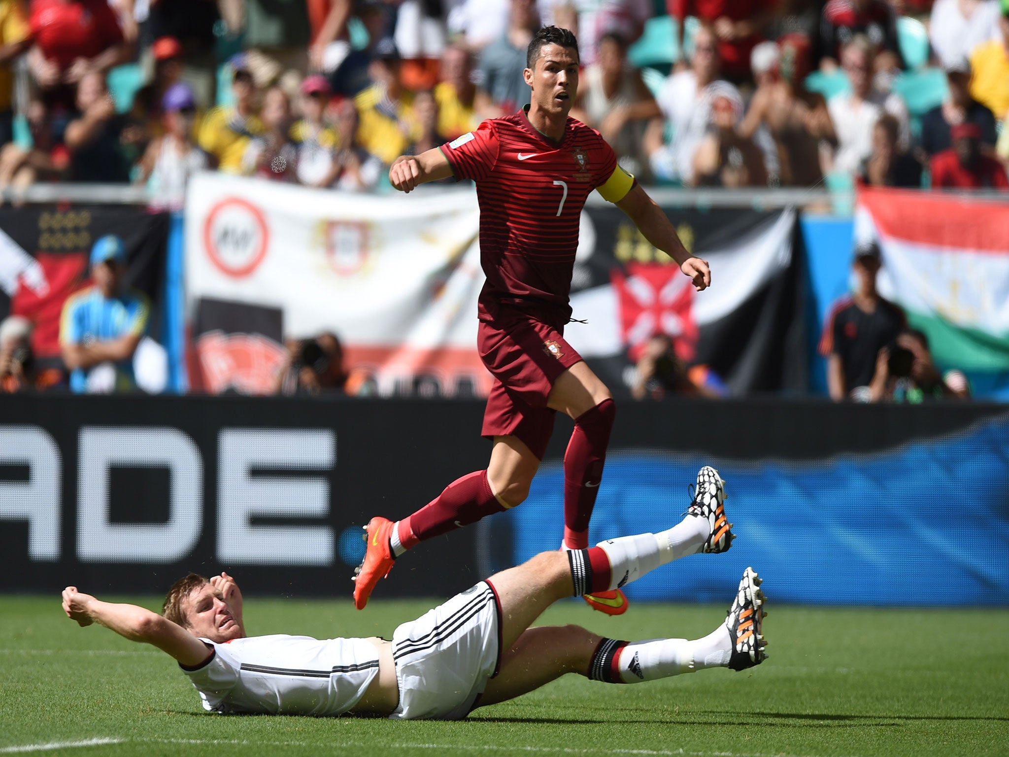 Cristiano Ronaldo skips Thomas Muller's challenge in the World Cup match between Germany and Portugal