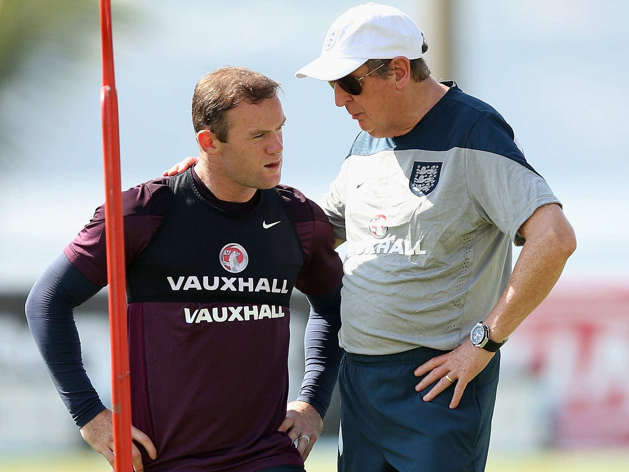 England striker Wayne Rooney speaks with Roy Hodgson