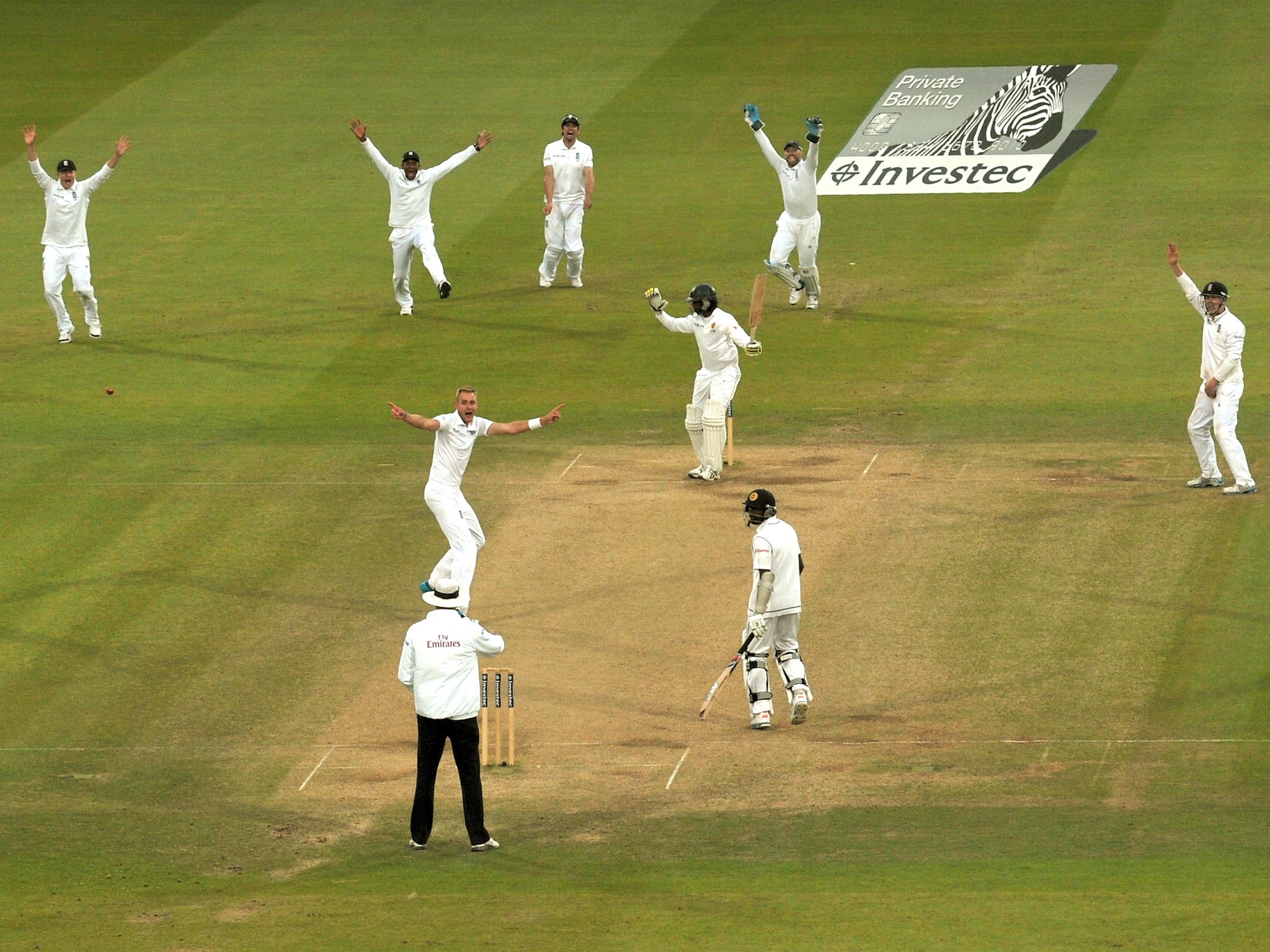 England players, led by paceman Stuart Broad, go up as one to appeal for the decisive wicket of Nuwan Pradeep at Lord’s. But celebrations were cut short when the decision was quickly overturned by DRS