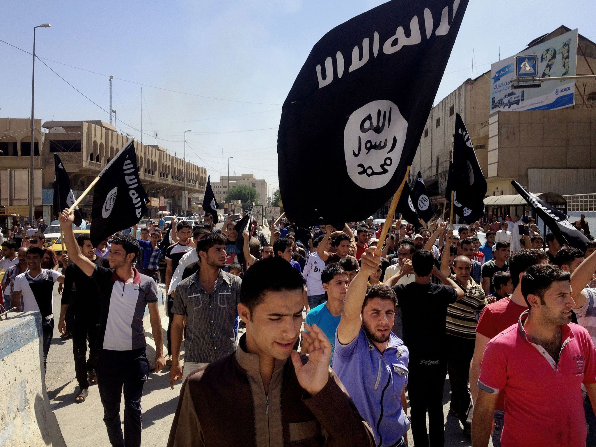 Demonstrators chant pro-al-Qaida-inspired Islamic State of Iraq and the Levant (ISIL) as they carry al-Qaida flags in front of the provincial government headquarters in Mosul, 225 miles (360 kilometers) northwest of Baghdad. In the week since it captured