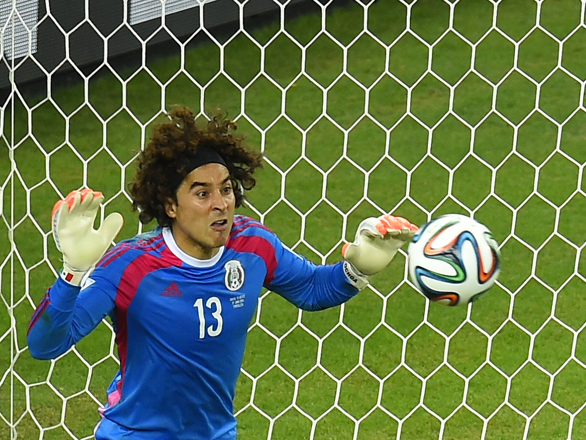 Mexico's goalkeeper Guillermo Ochoa saves an attempt at goal during a Group A football match between Brazil and Mexico in the Castelao Stadium in Fortaleza