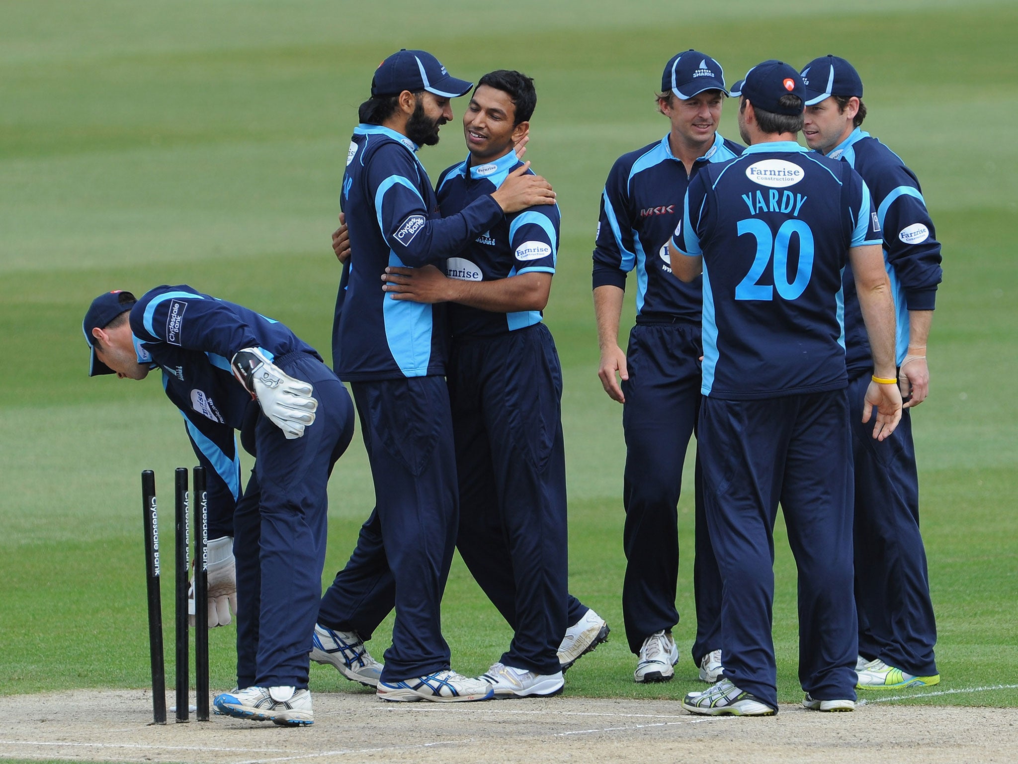 Monty Panesar of Sussex congratulates team mate Naveed Arif on bowling Scott Newman of Middlesex during the Clydesdale Bank 40 between Sussex and Middlesex