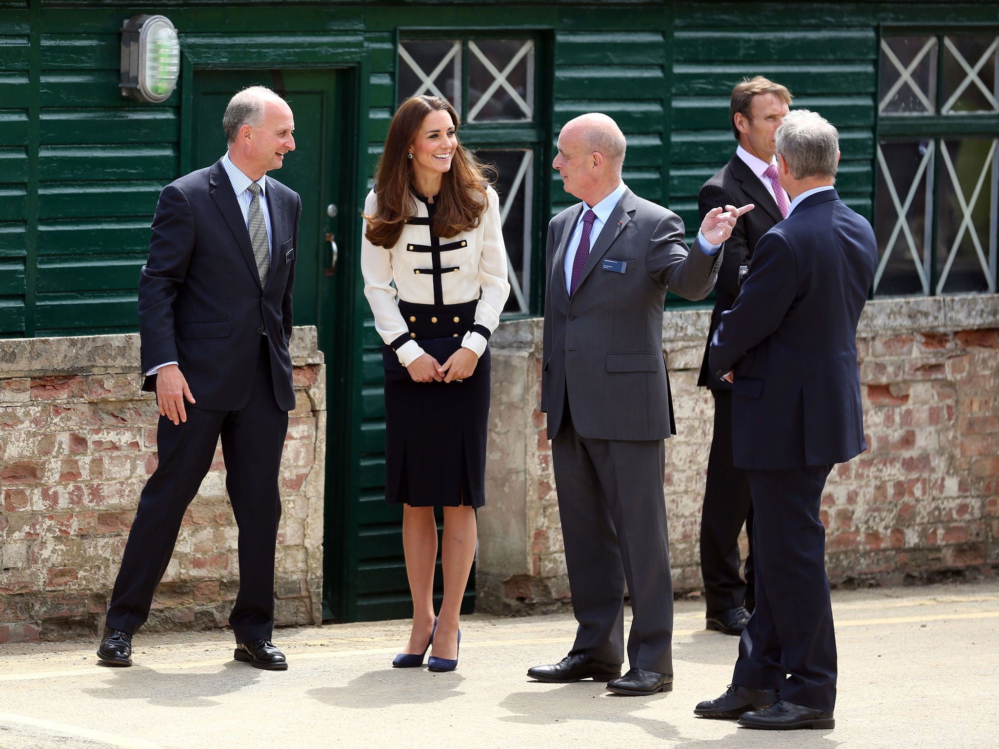 The Duchess of Cambridge talks with Sir John Scarlett (R) the Chairman of Bletchley Park during a visit to the former wartime spy centre in Buckinghamshire to mark the completion of a year-long restoration project, which has returned the buildings to thei