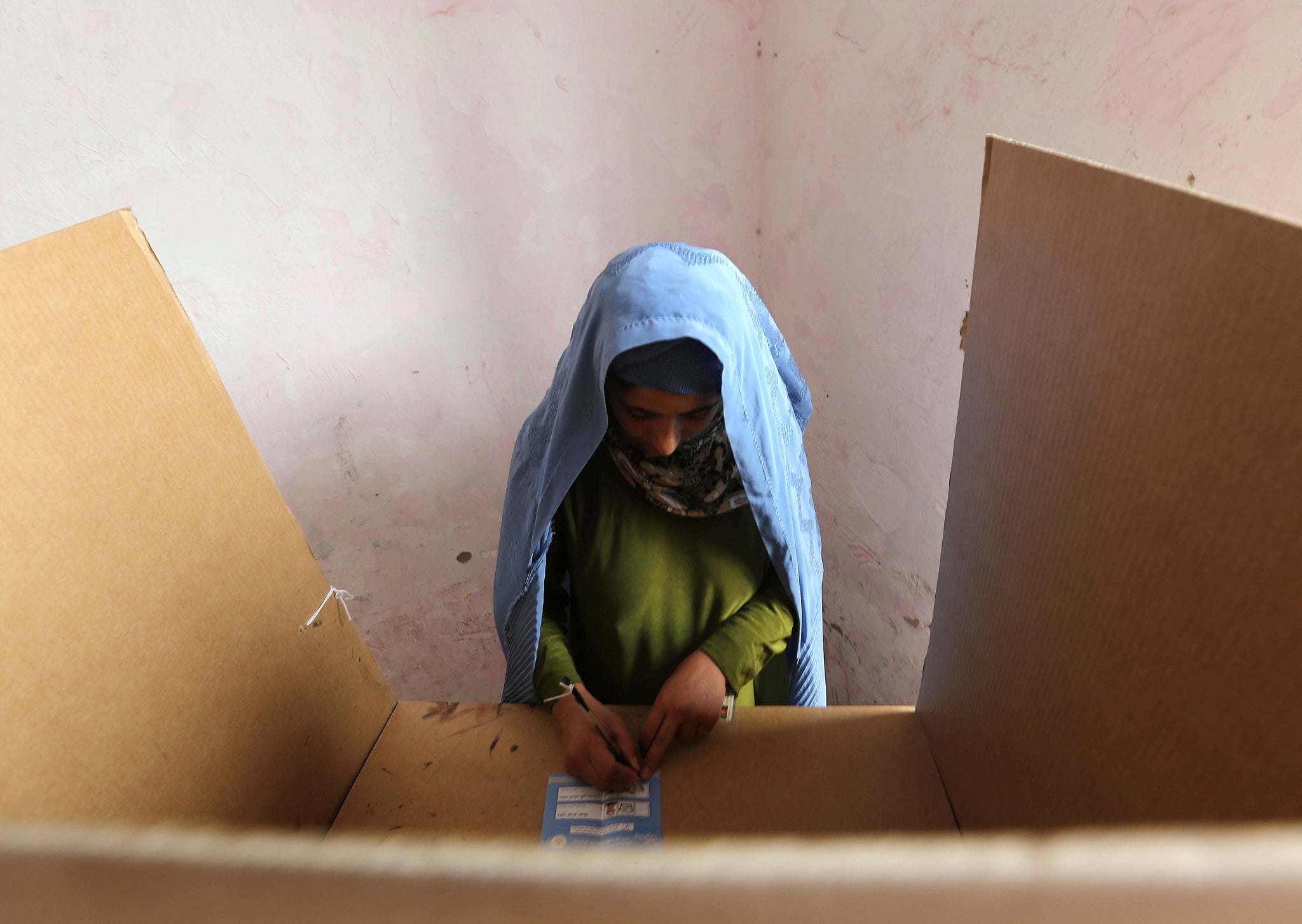 An Afghan woman casts her vote on Saturday