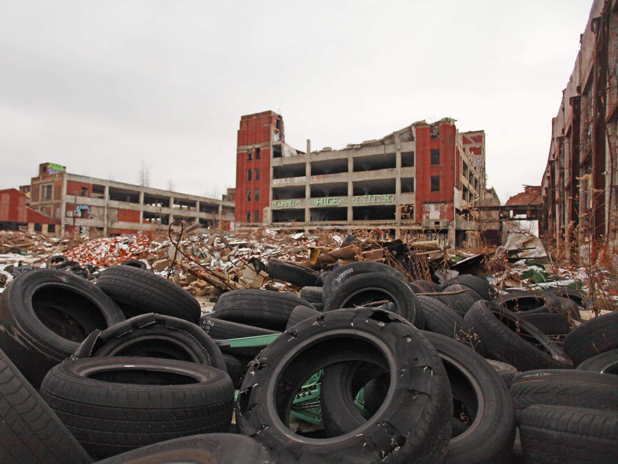 Old tires rest near the abandoned Packard Automotive Plant in Detroit (Getty)