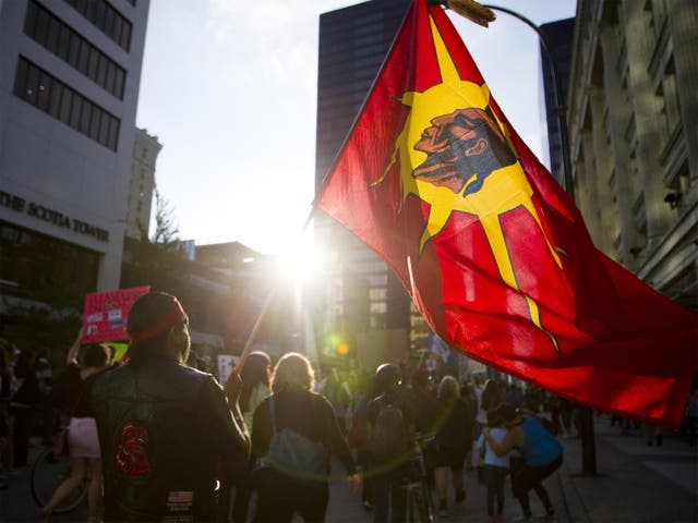 Demonstrators protest in the streets following the federal government's approval of the Enbridge's Northern Gateway pipeline in Vancouver, British Columbia 