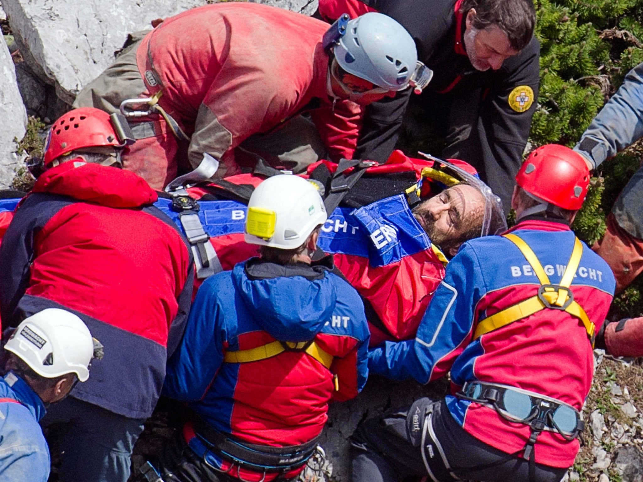Rescue helpers carry injured cave explorer Johann Westhauser on a stretcher near the entrance to the Riesending cave at Untersberg mountain, Germany, 19 June 2014