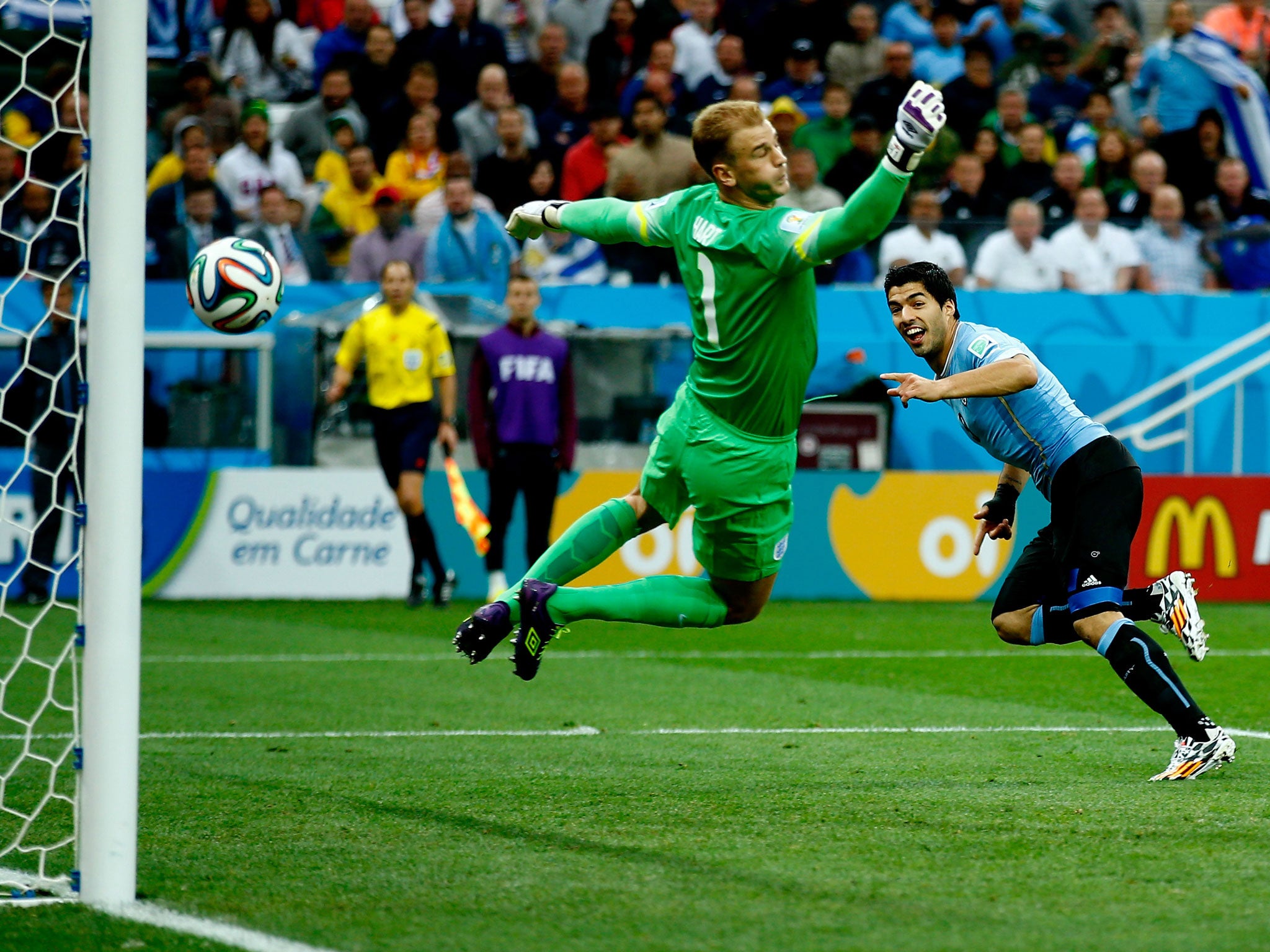 Suarez heads the ball past Hart during the 2-1 defeat to Uruguay