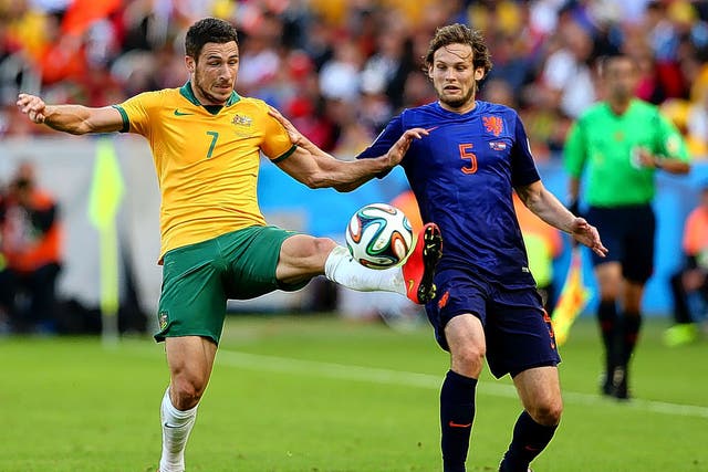 Matthew Leckie of Australia challenges Holland’s Daley Blind in their group B game. I would take a chance on bringing both to the Premier League