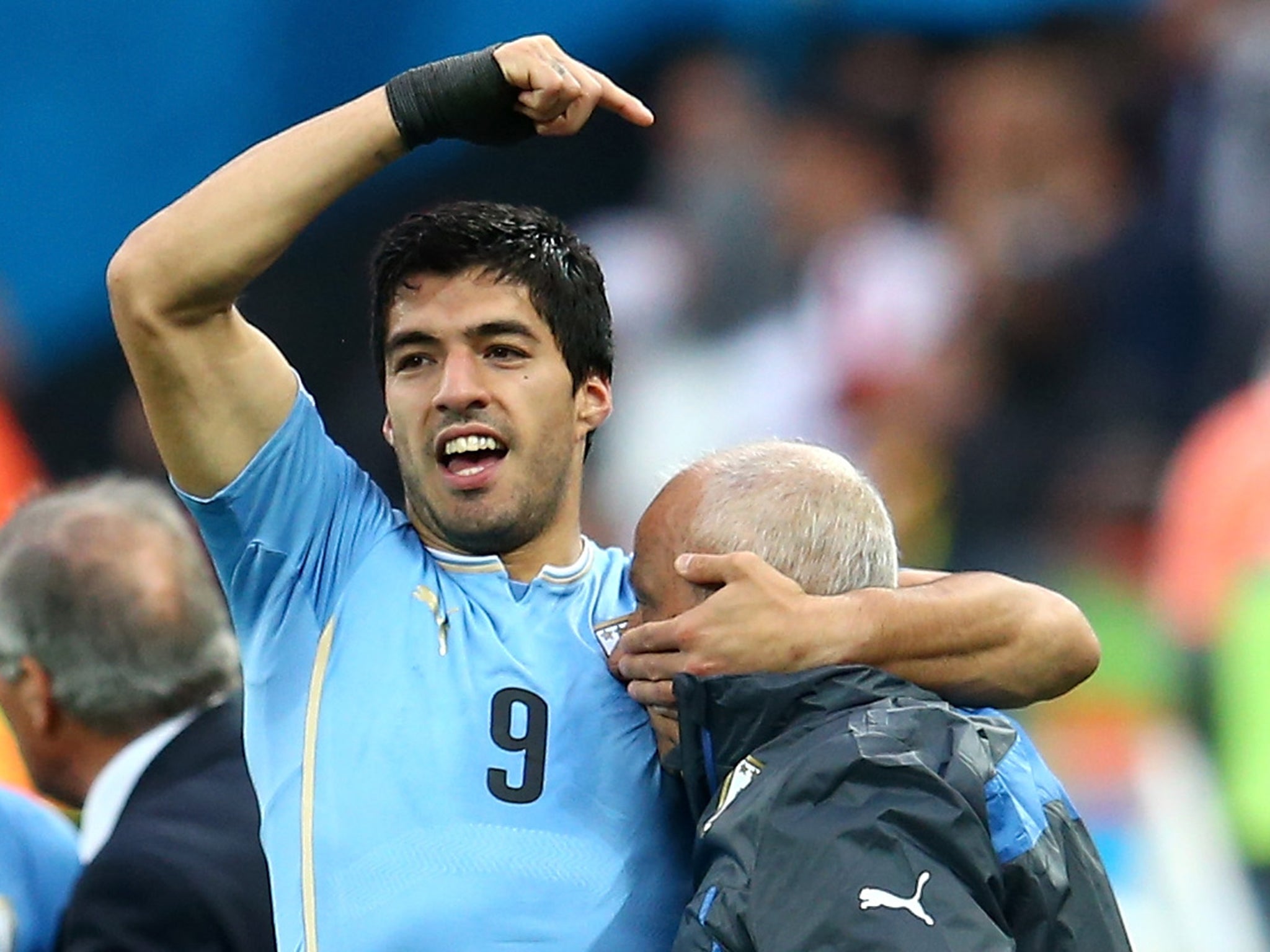 Luis Suarez with doctor Walter Ferreira after Uruguay's 2-1 win over England