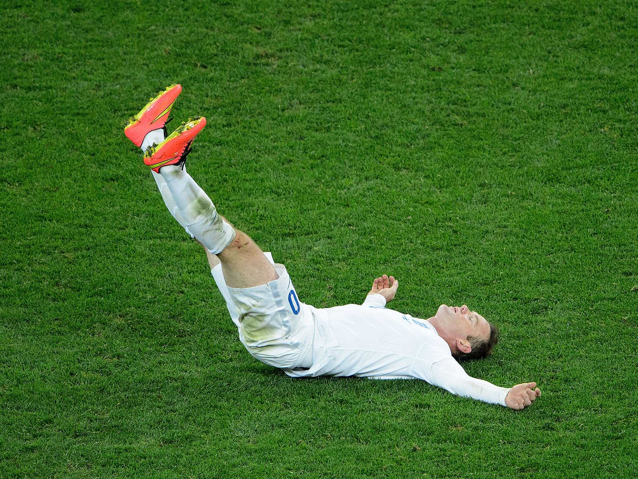 Down and out, Rooney slumps to the ground after England's 2-1 defeat to Uruguay