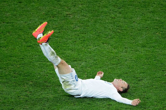 Down and out, Wayne Rooney slumps to the ground after England's 2-1 defeat to Uruguay