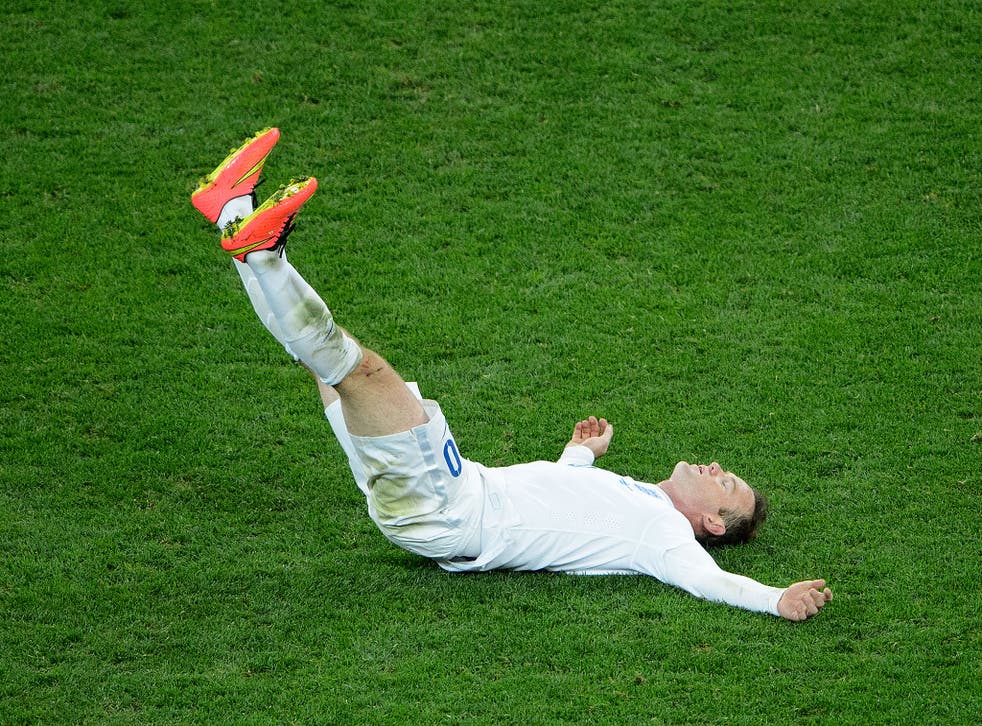 Down and out, Wayne Rooney slumps to the ground after England's 2-1 defeat to Uruguay
