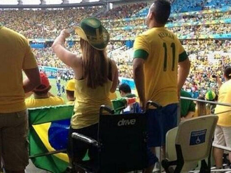 Police are investigating pictures of fans apparently standing out of wheelchairs at Brazil's match against Croatia.