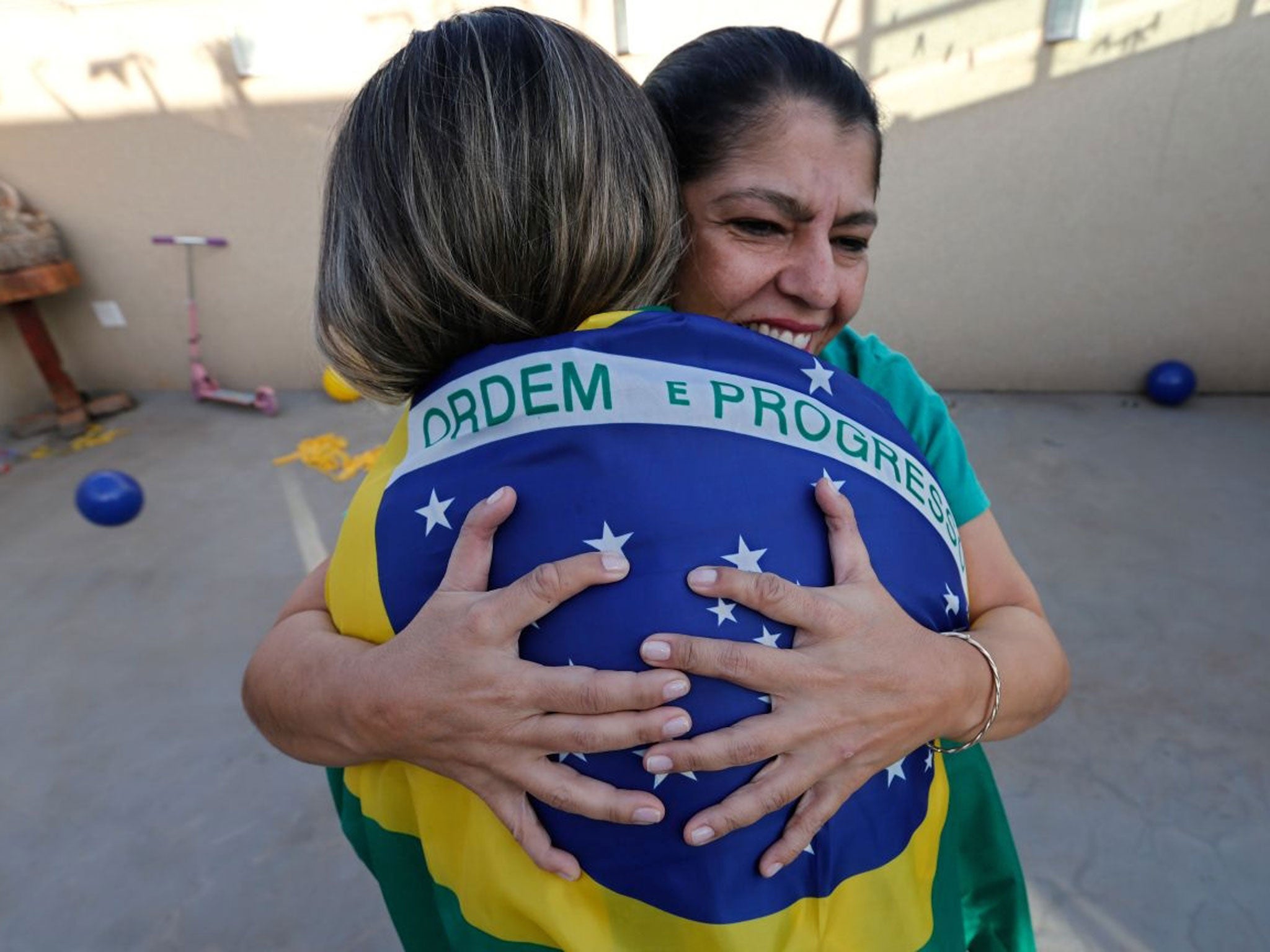 Silvia Santos, facing camera, embraces her daughter Ana Carolina (AP)