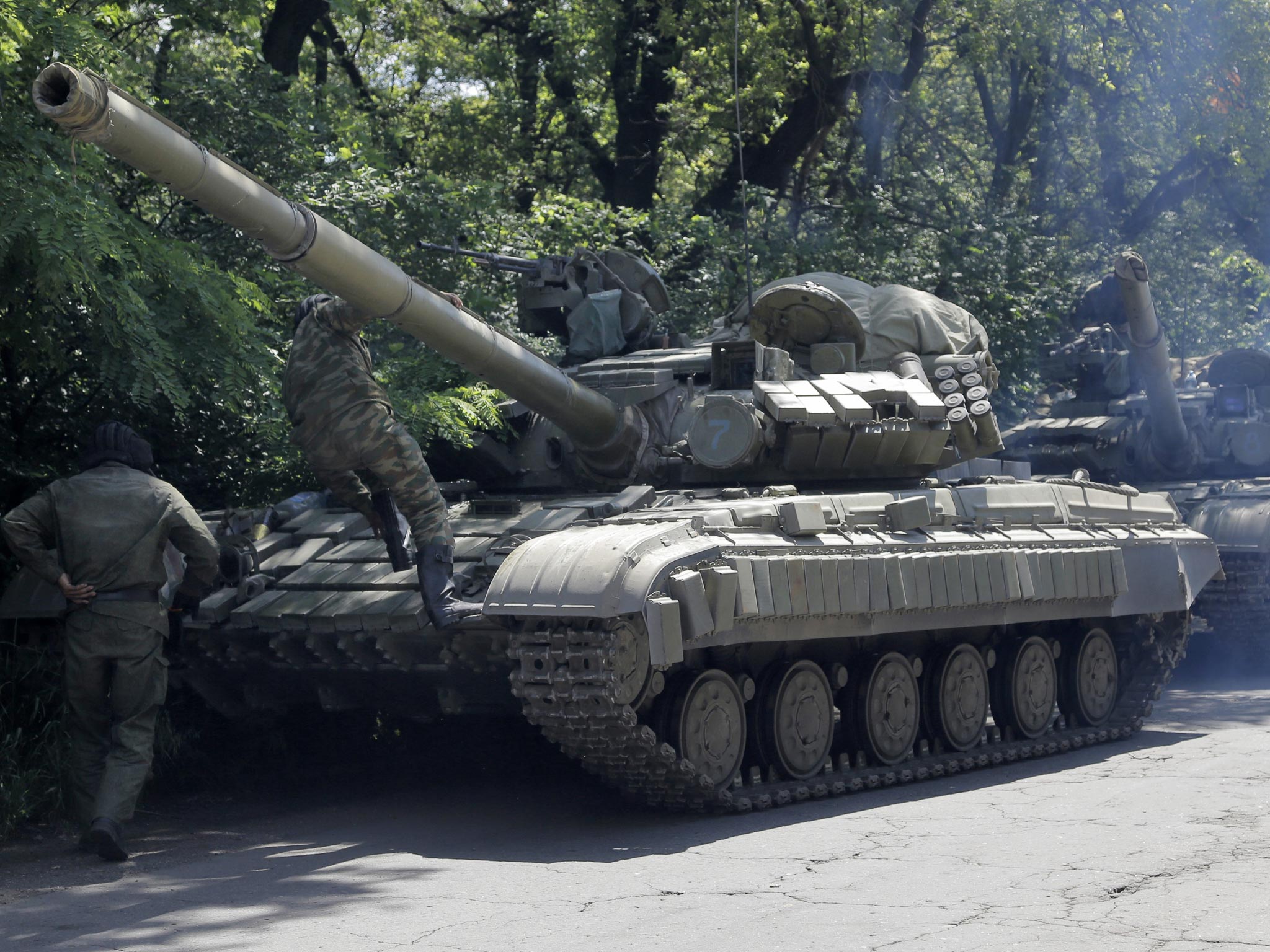 Pro-russian troops prepare to travel in a tank on a road near the town of Yanakiyevo, Donetsk region