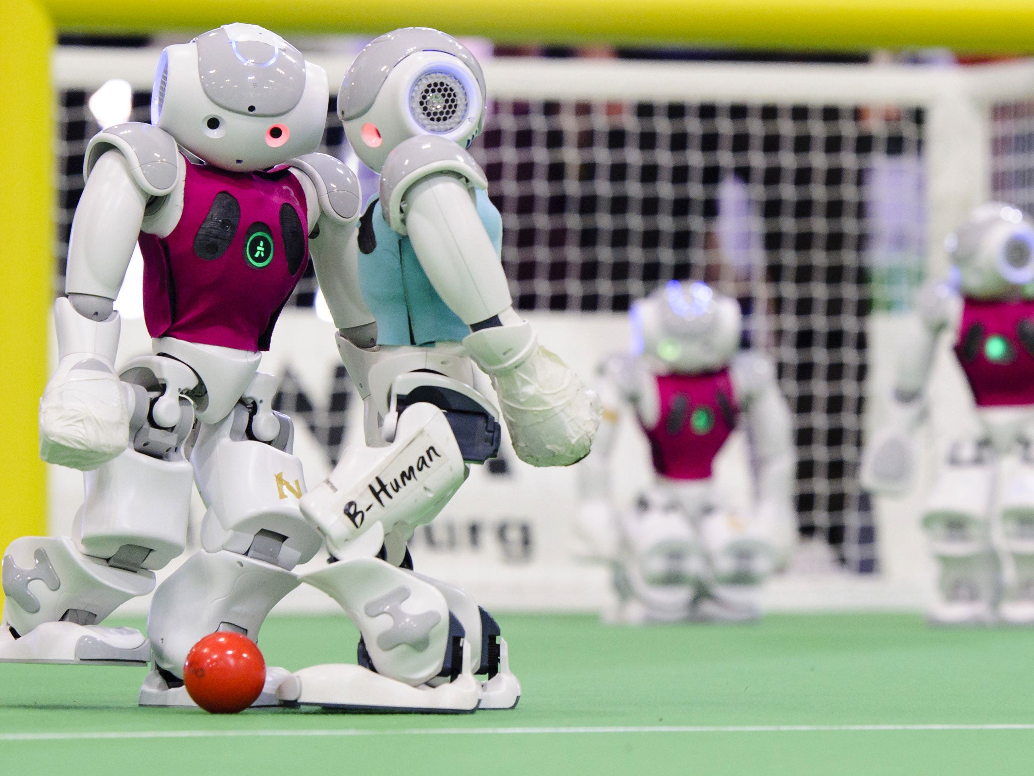 Two teams of robots play against each other in the 2014 RoboCup German Open tournament on April 03, 2014 in Magdeburg, Germany.