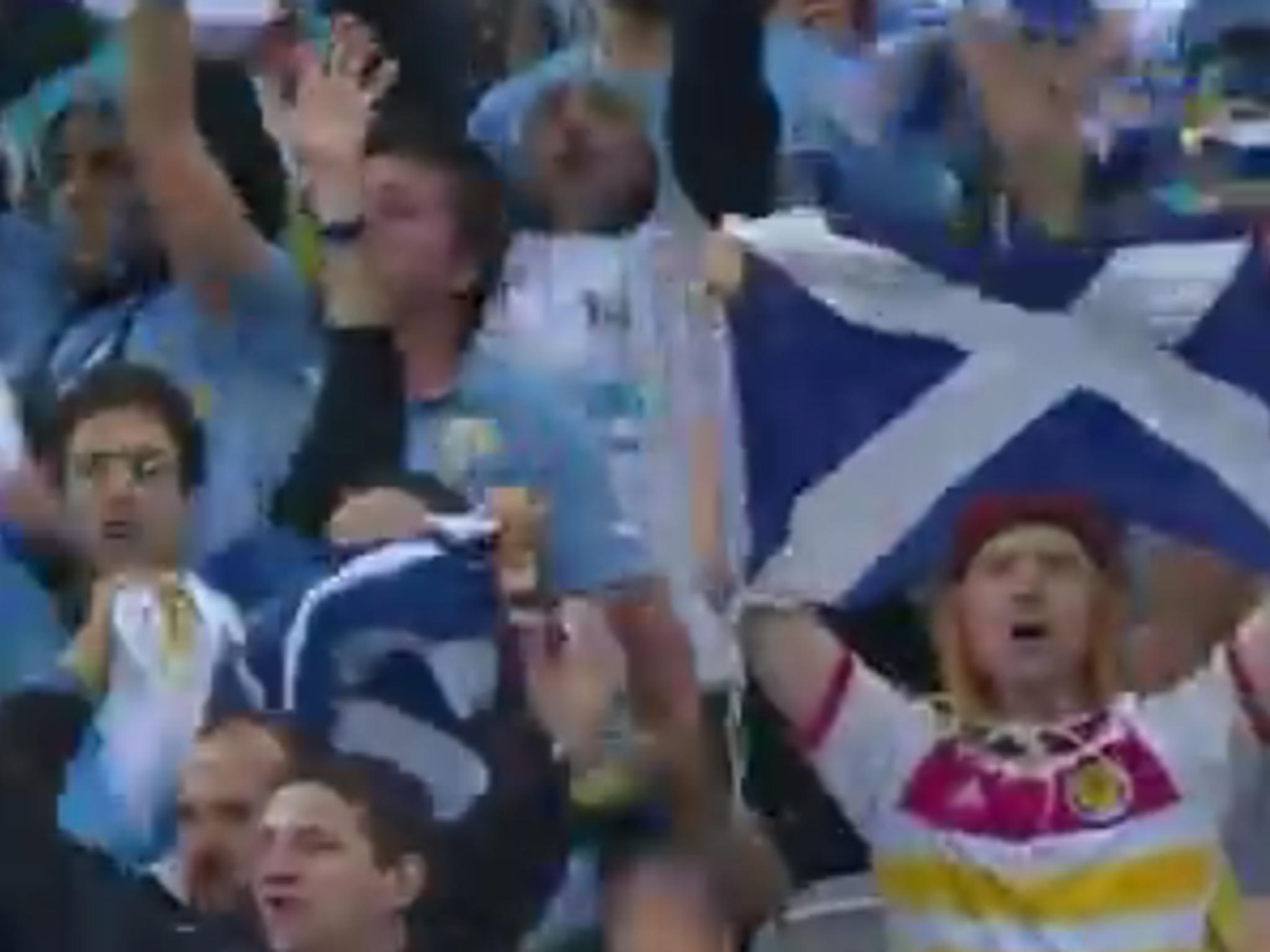 Flag of convenience: Scot Mark McConville surrounded
by Uruguay fans as they celebrate the defeat of England