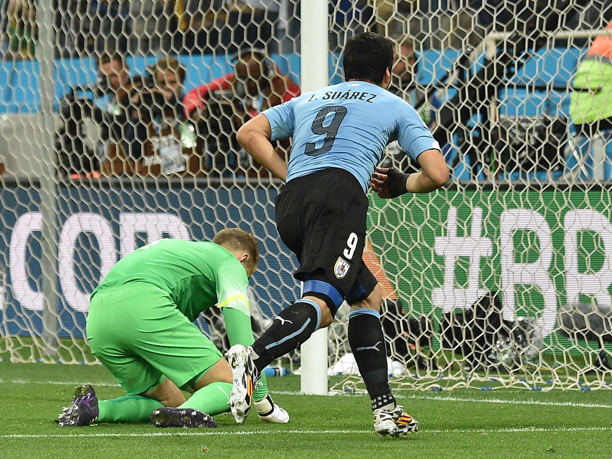 Luis Suarez runs away in triumph after making England pay the full price for their late defensive lapse