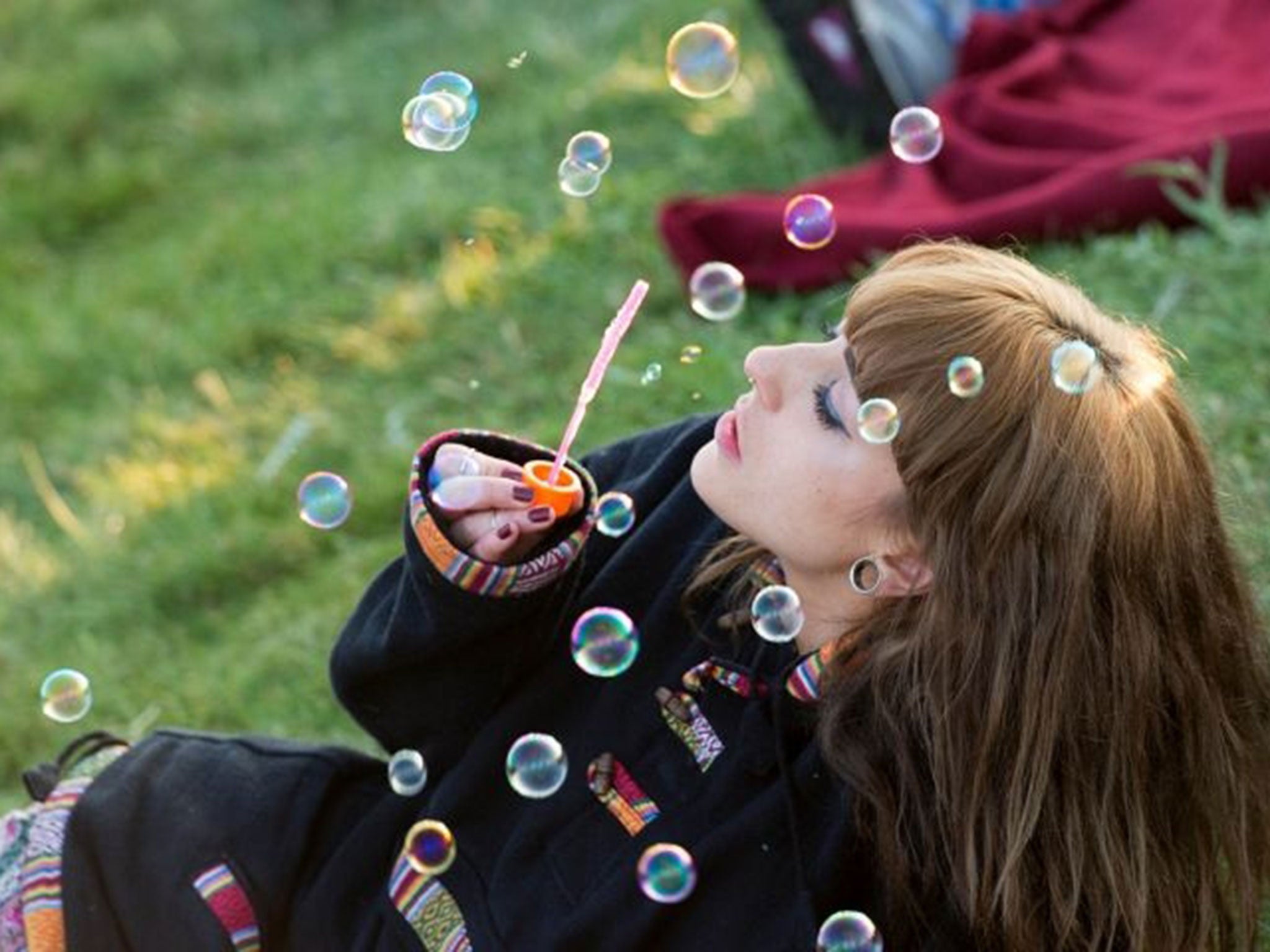 A girl takes part in the summer solstice dawn celebrations after druids, pagans and revellers gathered for the Summer Solstice sunrise at Stonehenge