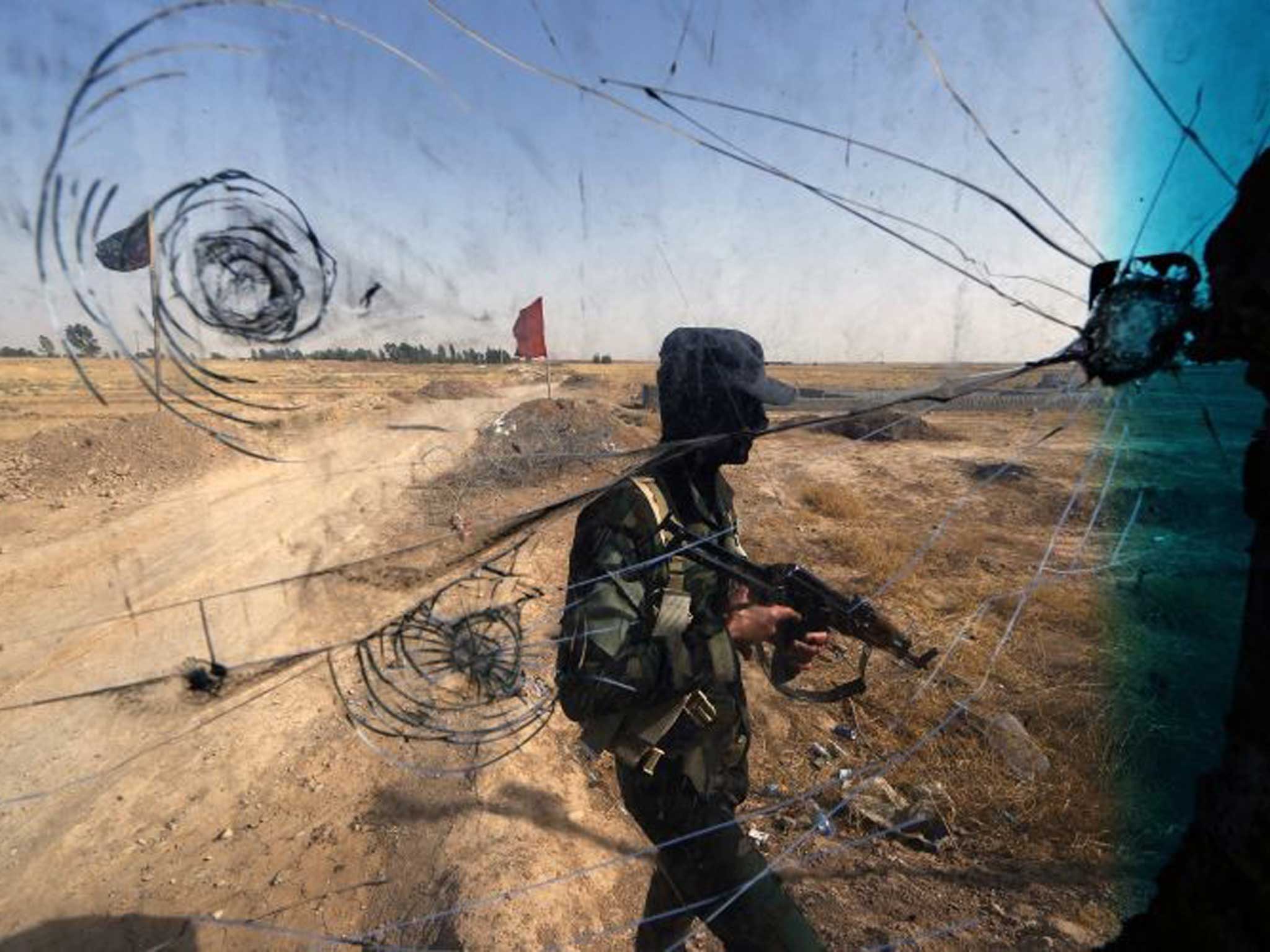 On guard: Iraqi Turkmen forces man a checkpoint in the northern city of Tuz Khurmatu
