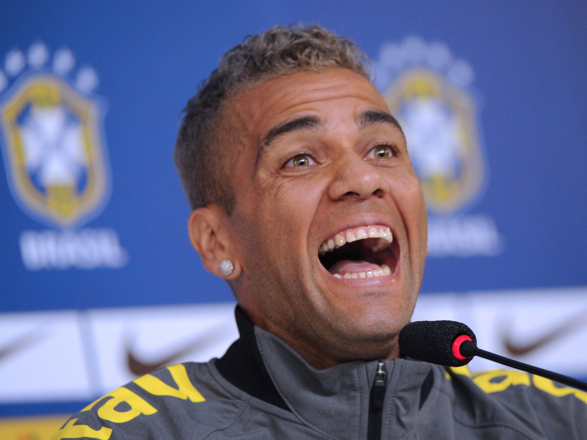 Daniel Alves laughs during a press conference