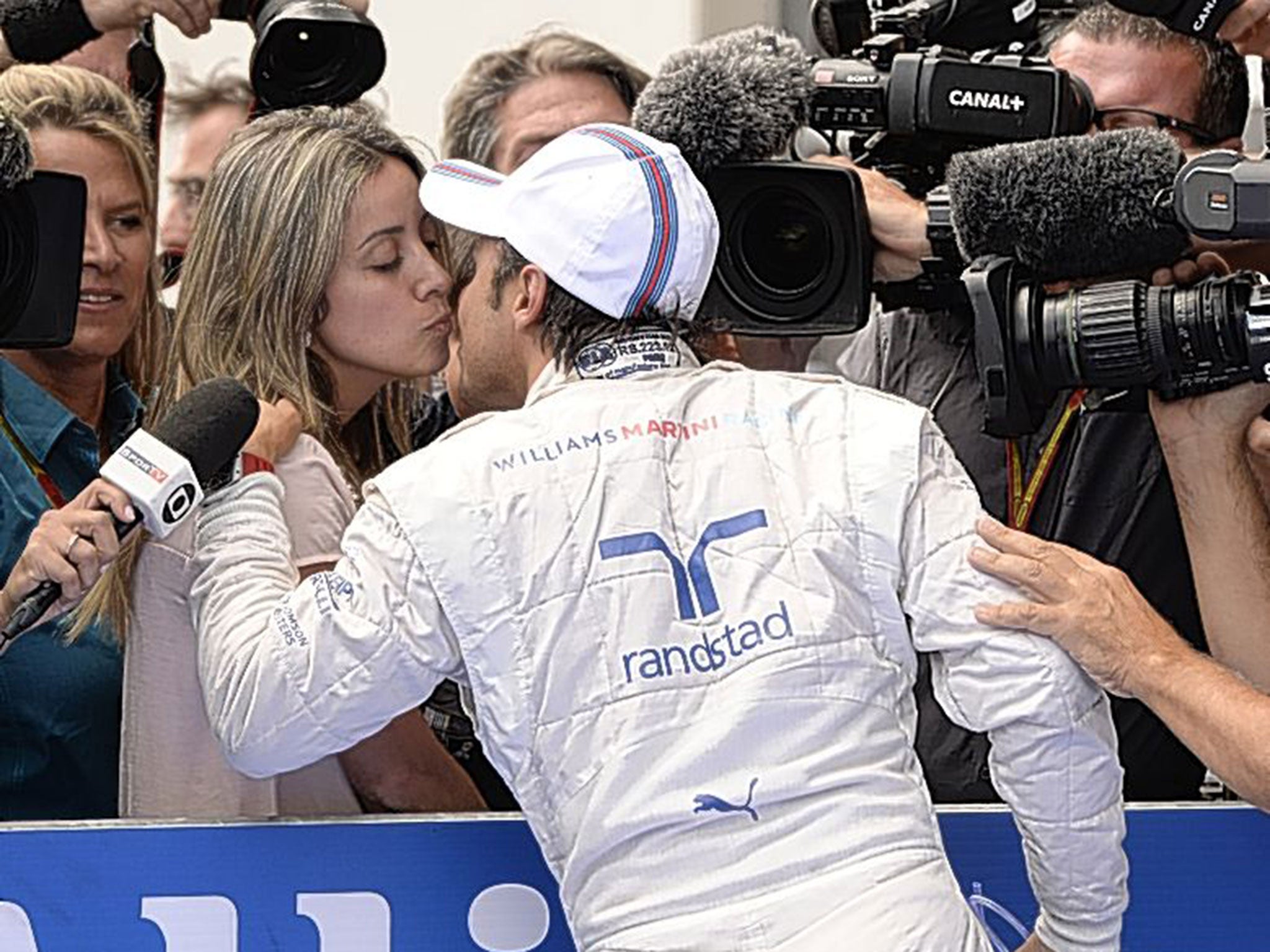 On centre stage: Williams’ Felipe Massa is kissed by his wife, Raffaela