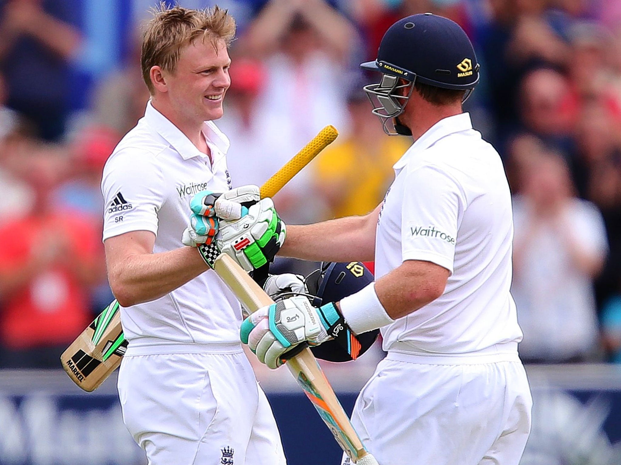 Sam Robson is congratulated by Ian Bell on reaching his maiden century off 220 balls; he was more expansive later