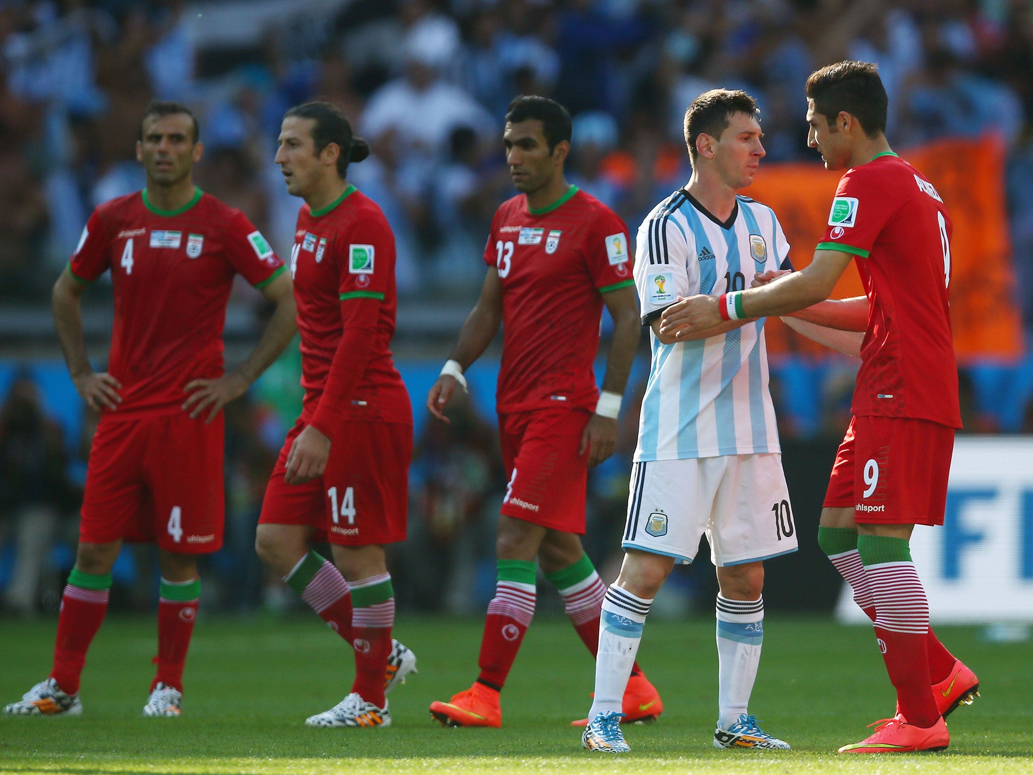 Iran's players congratulate Lionel Messi after the match