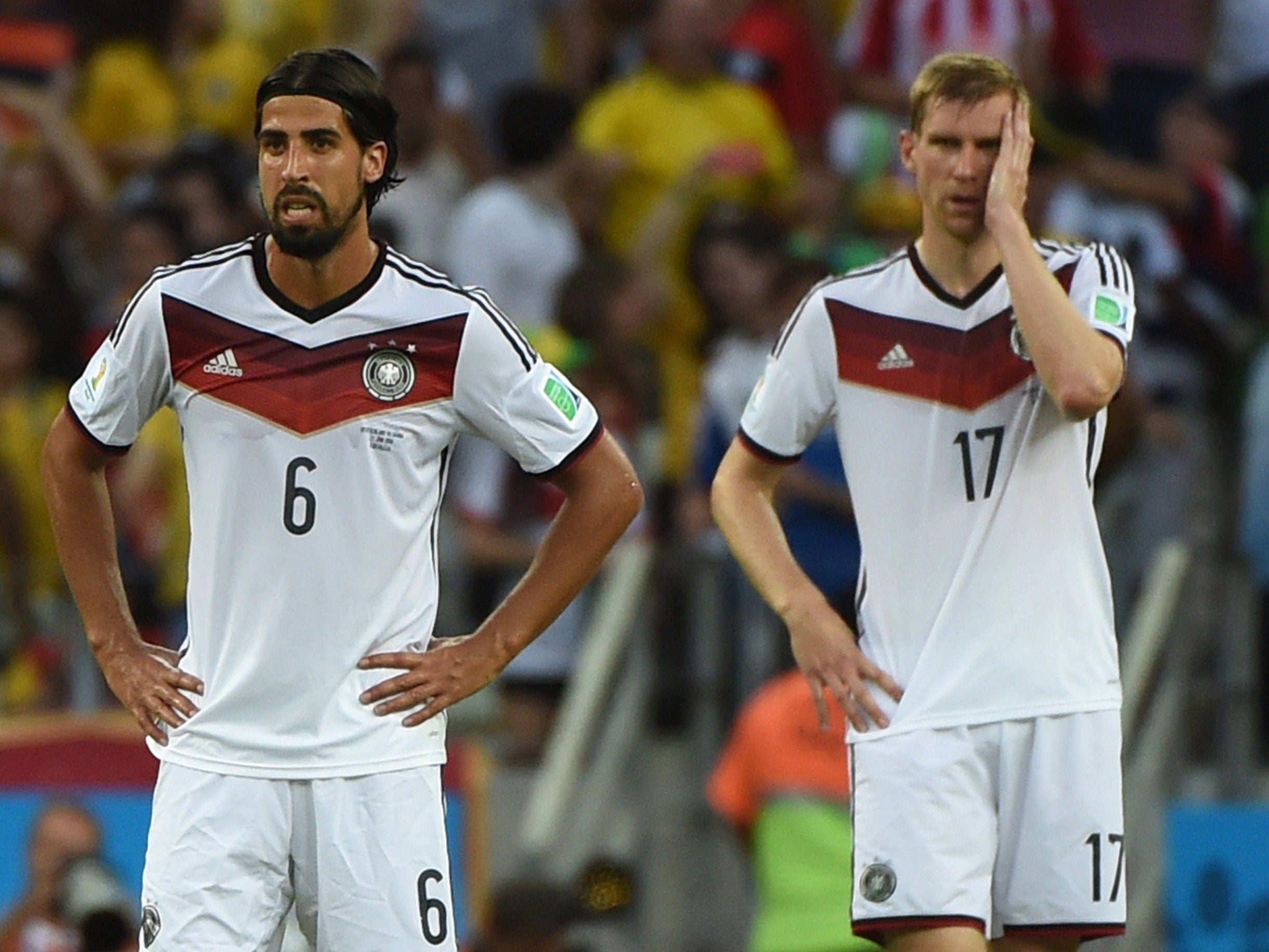 Sami Khedira and Per Mertesacker react after Germany fell behind to Ghana