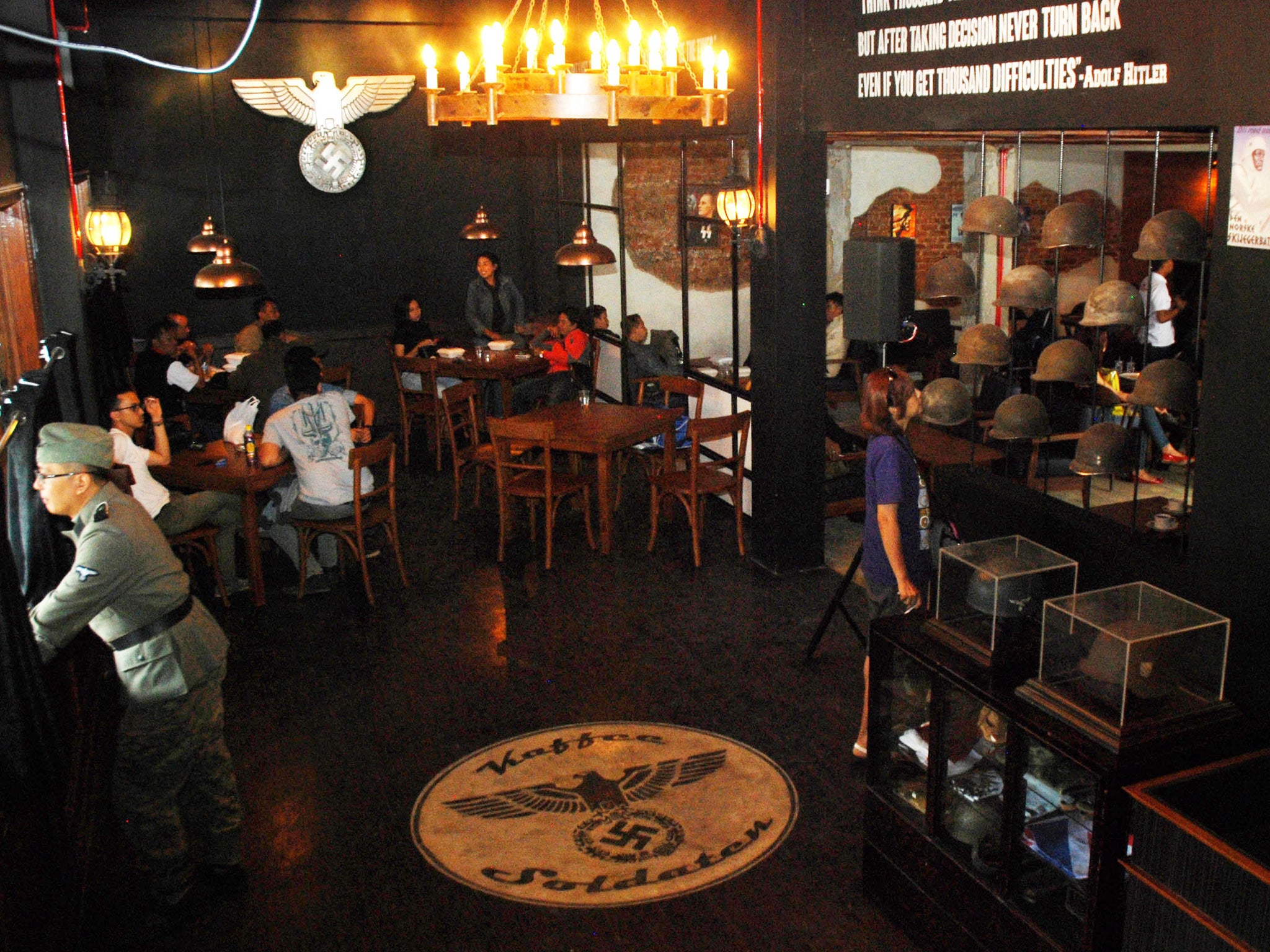 The cafe still features swastikas, Nazi insignia and a painting of Adolf Hitler, as well as a large Nazi emblem on the floor.
