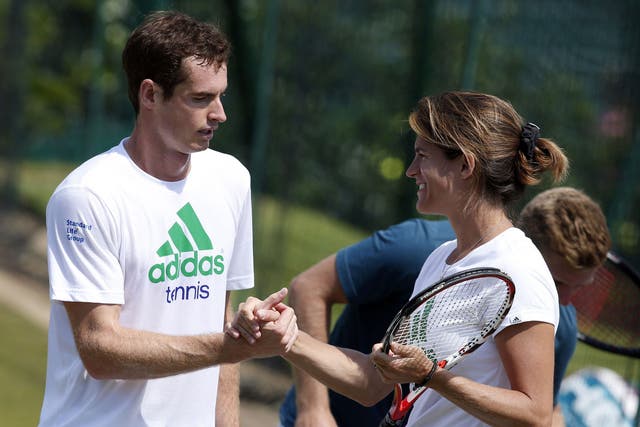 Murray and Mauresmo shake hands after a training session at the All England Tennis Club