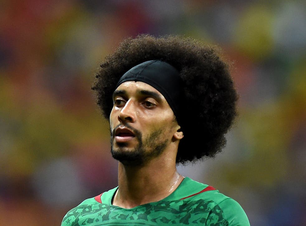 We're not sure if the hairband at the front of Benoit Assou-Ekotto's hair is to stop his afro getting in his eyes, or to protect his forehead when he decides to butt his Cameroon team-mates.