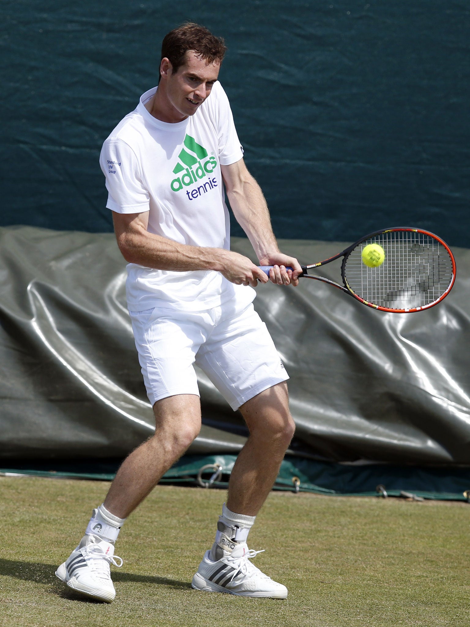 Andy Murray returns the ball during a practice session